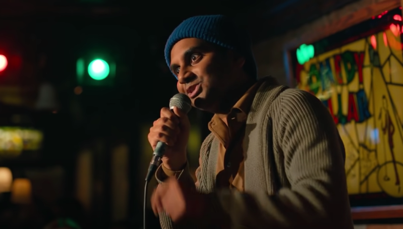 man in blue beanie talking into a microphone