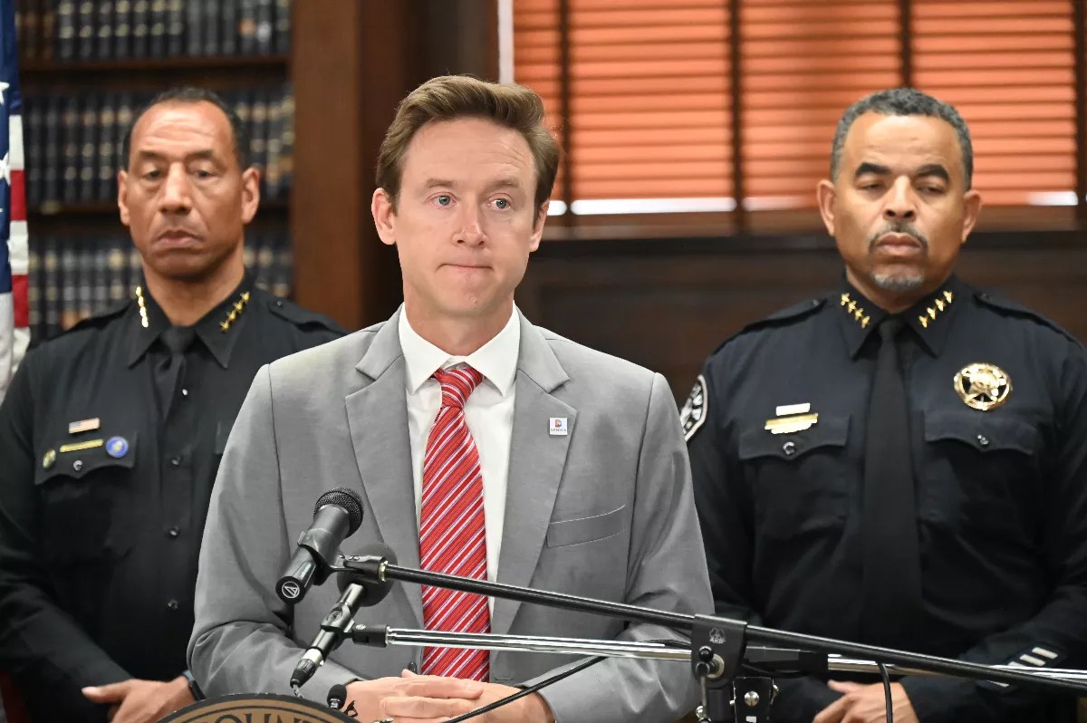 Denver Mayor Mike Johnston speaks to the press.