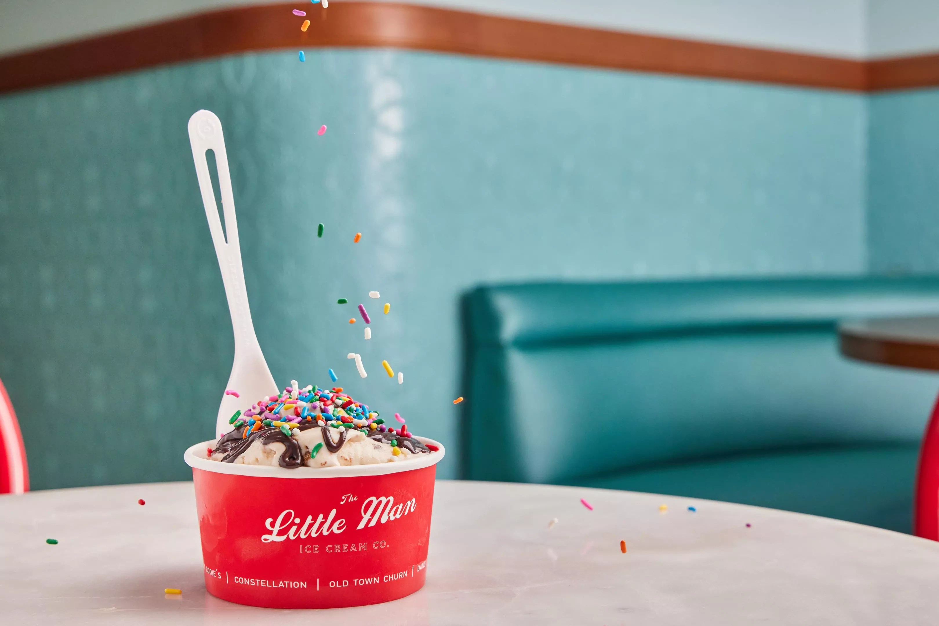 sprinkles falling on a cup of ice cream