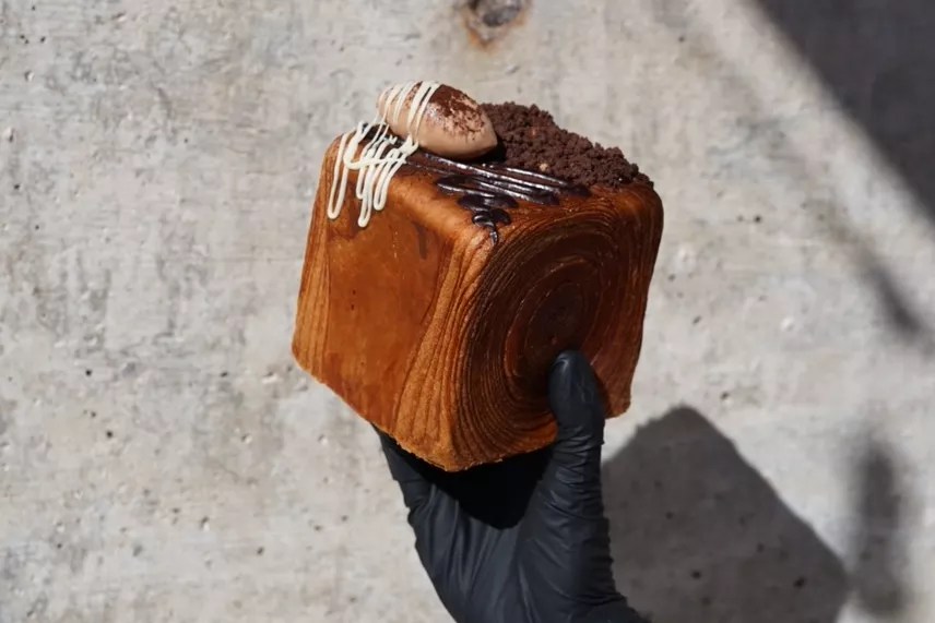 hand holding a croissant cube