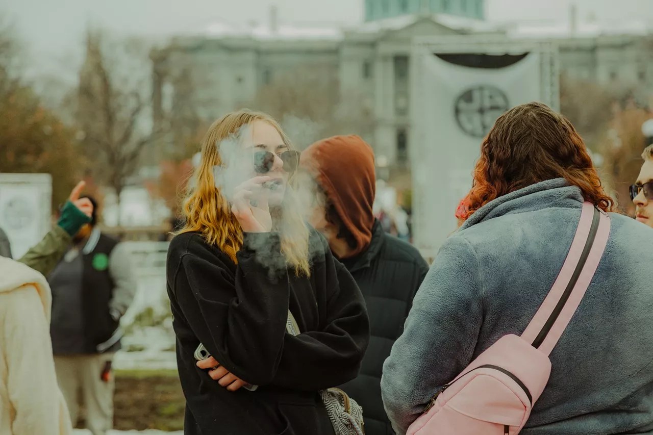 Woman smokes a joint at Denver 420 festival