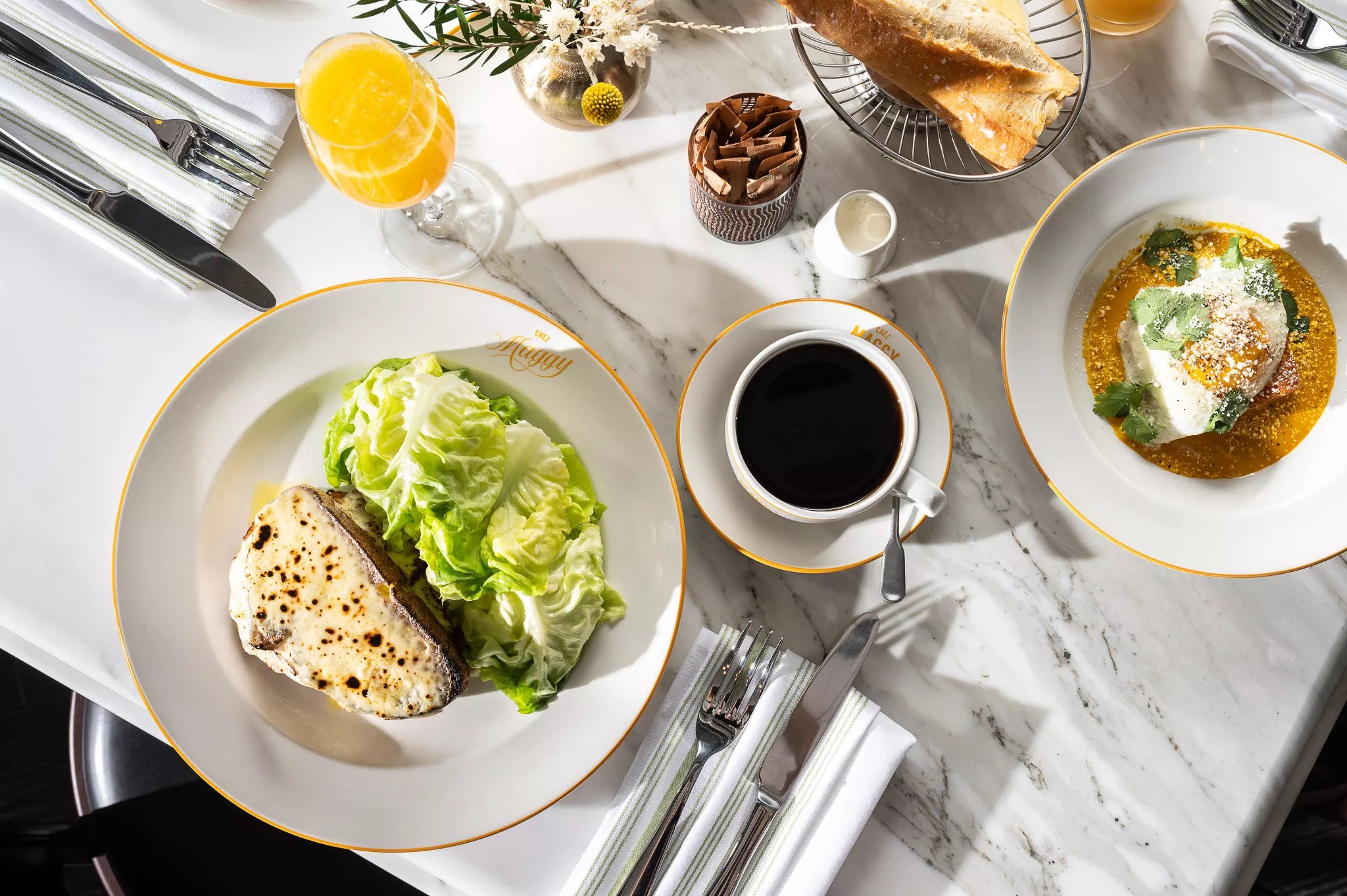 Croque monsieur and a cup of coffee on a white marble table