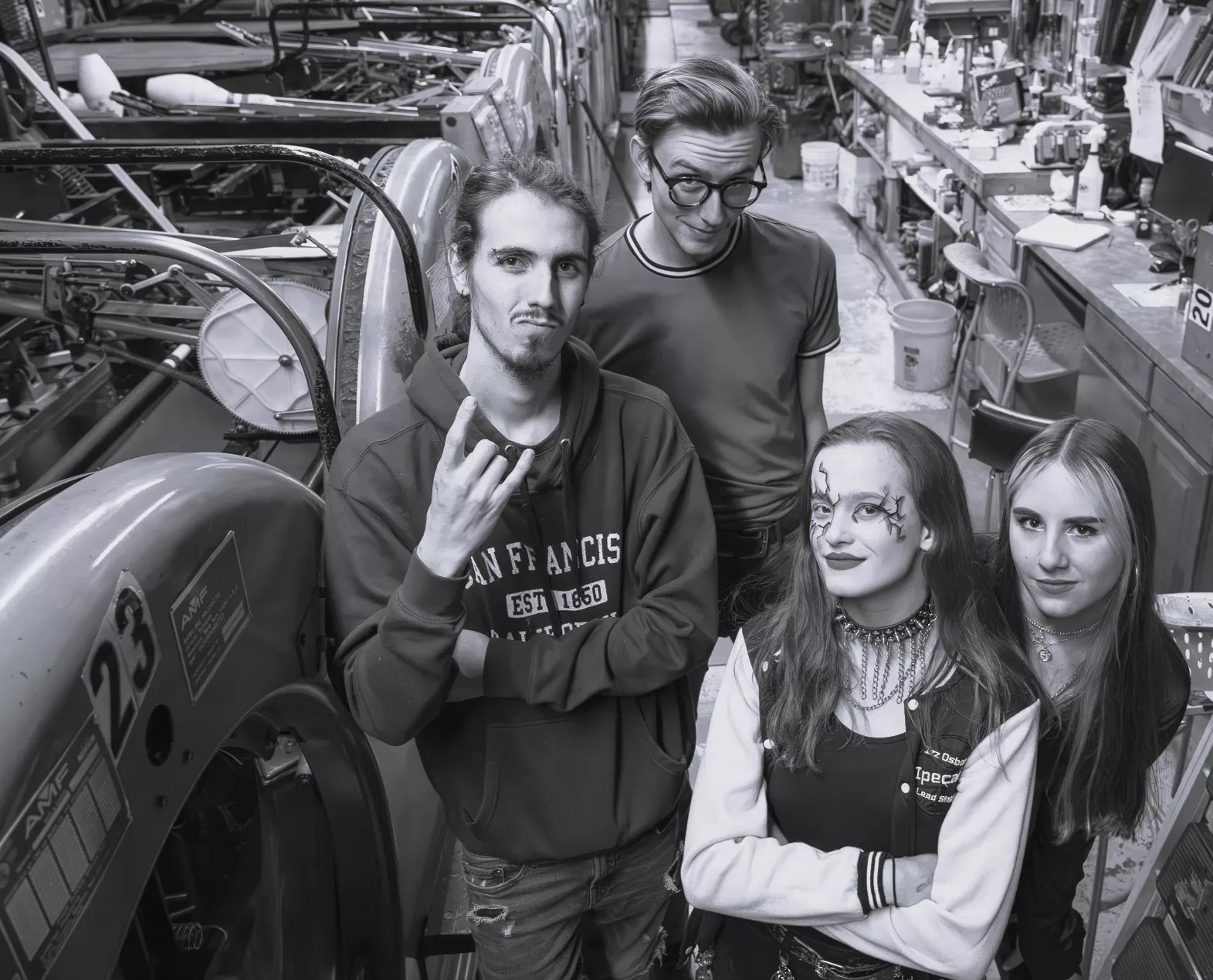 black and white image of four band members