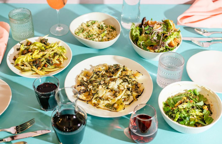 various food on white plates set on a light blue table