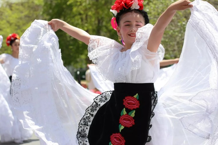woman in Mexican dress dancing.