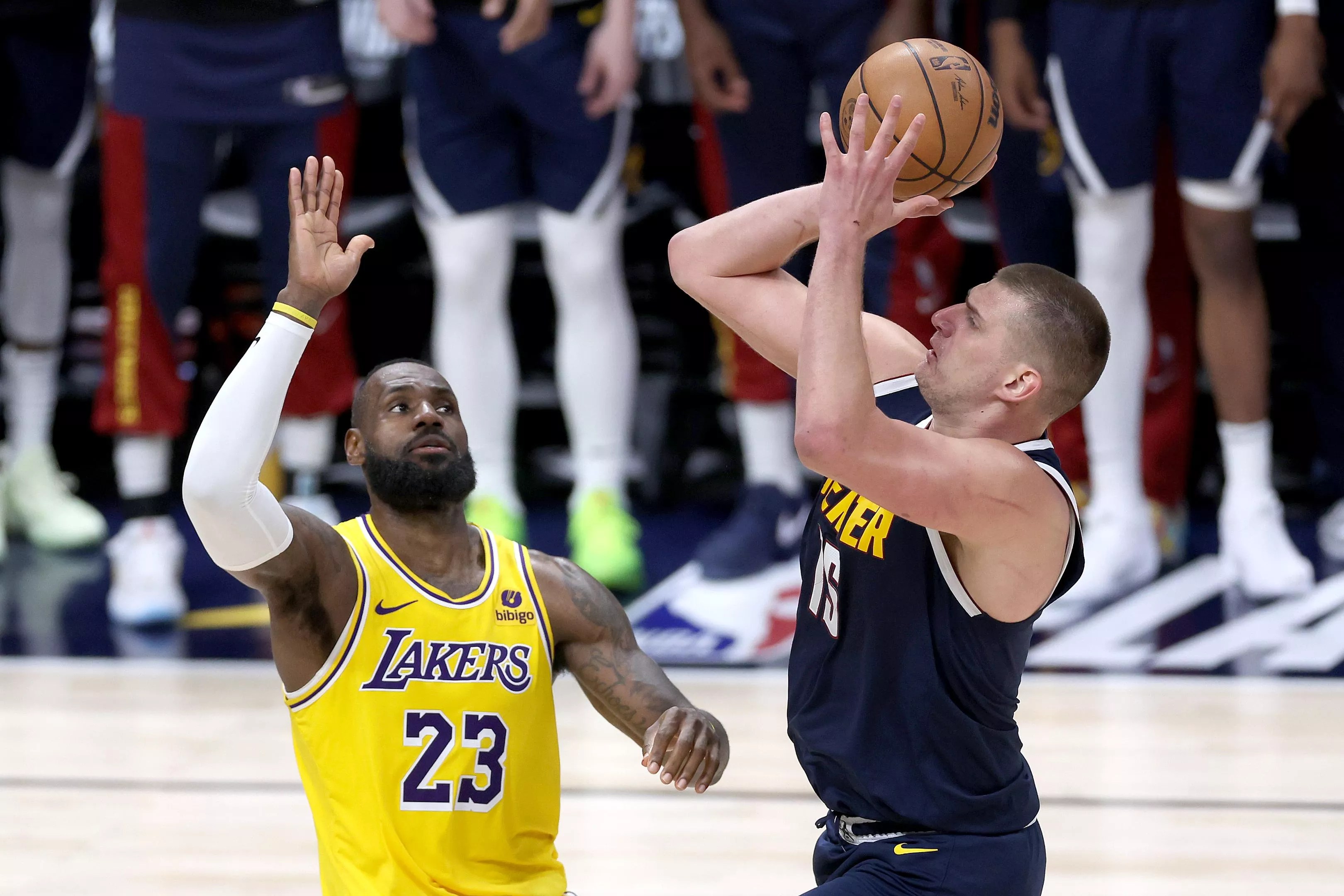 Nikola Jokic shoots over LeBron James