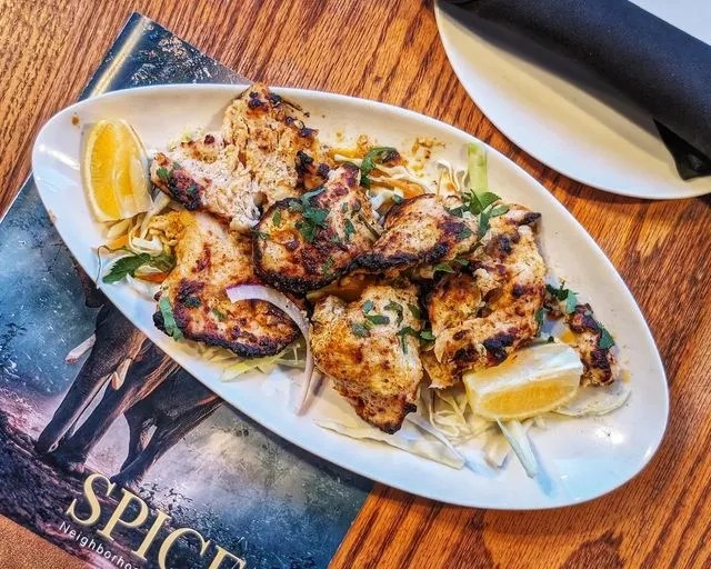 chicken kabobs on a white oval plate
