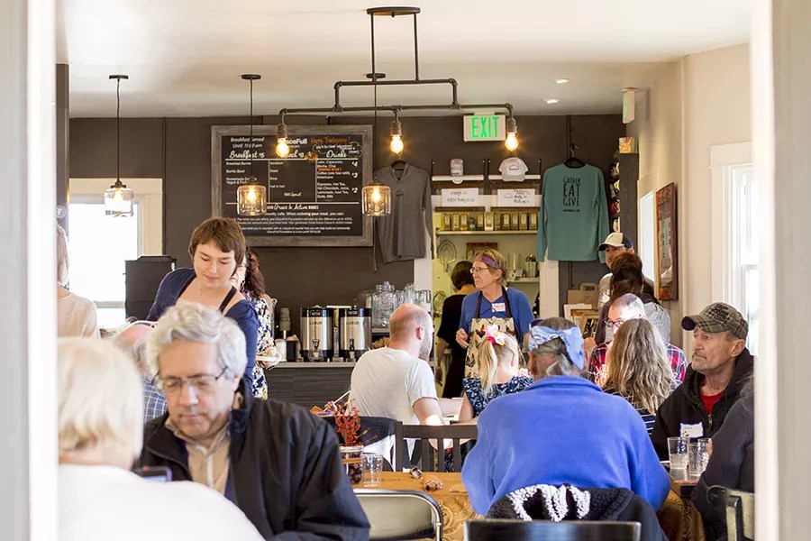 Patrons seated inside the intimate interior of GraceFull Cafe