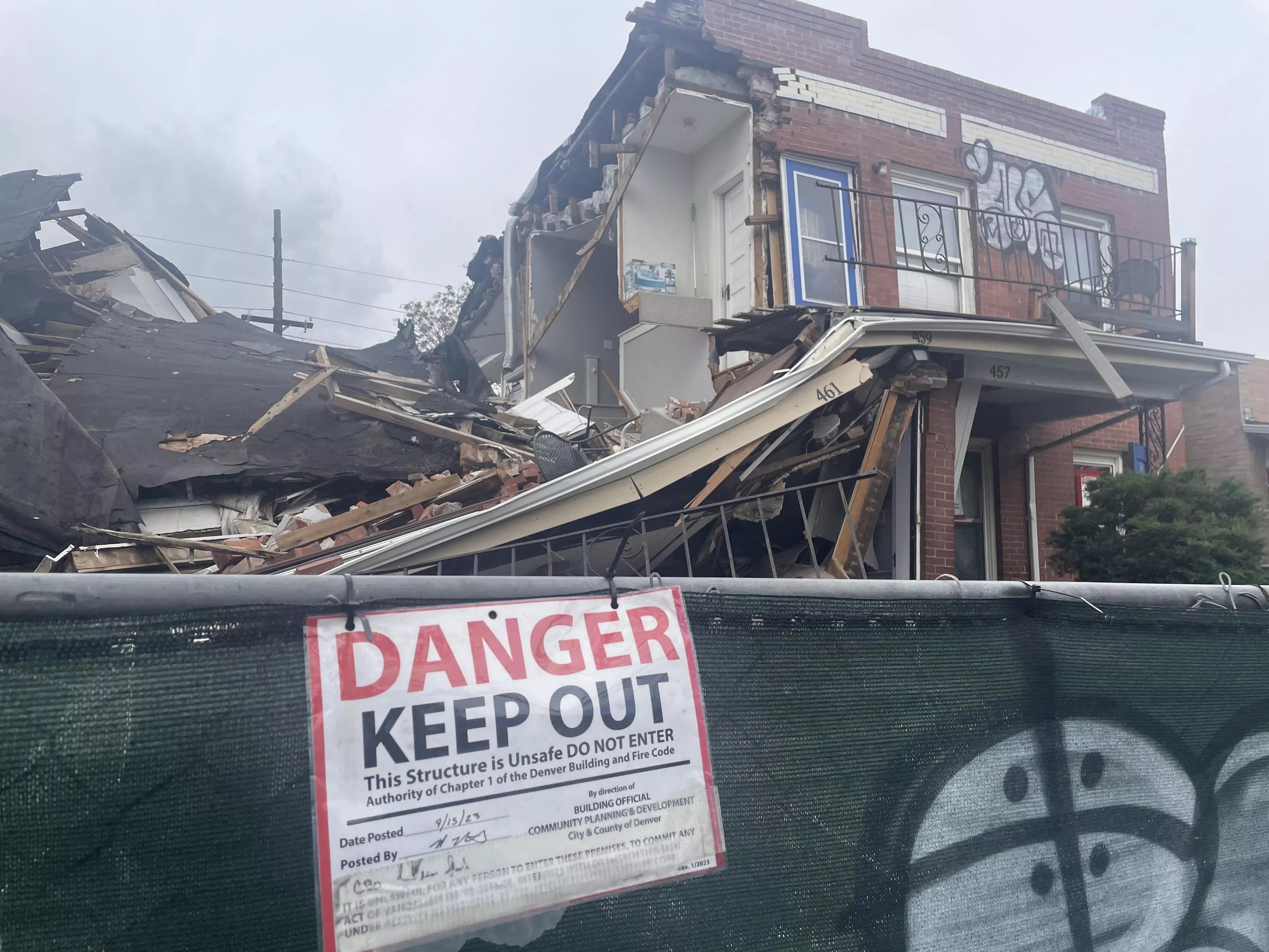 Destroyed house with warning signs