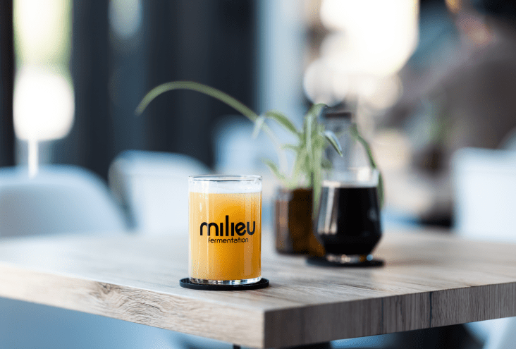 Glass of hazy IPA beer on a table.