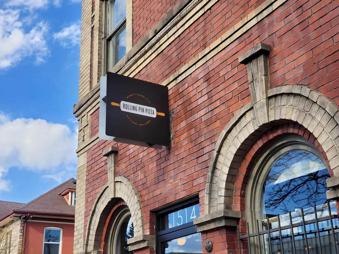 black sign on a brick building