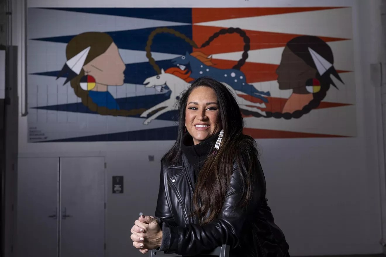 woman in leather jacket in front of art