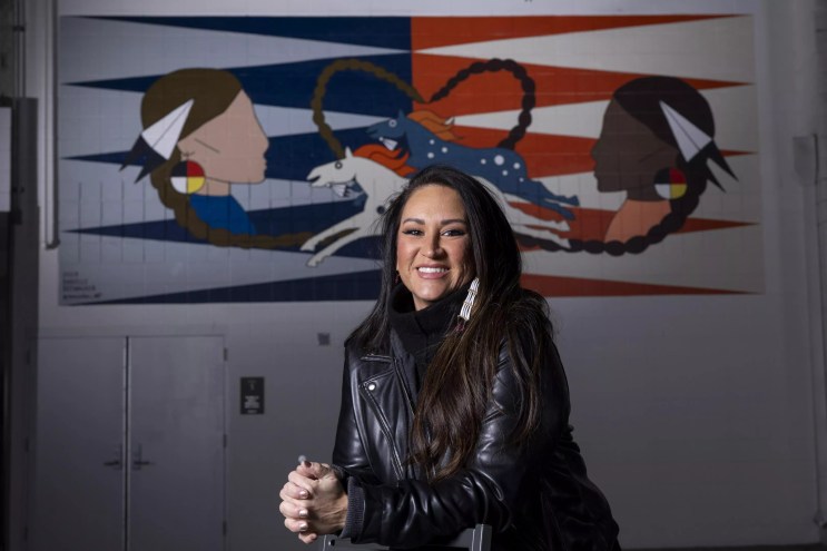 woman sitting in front of art