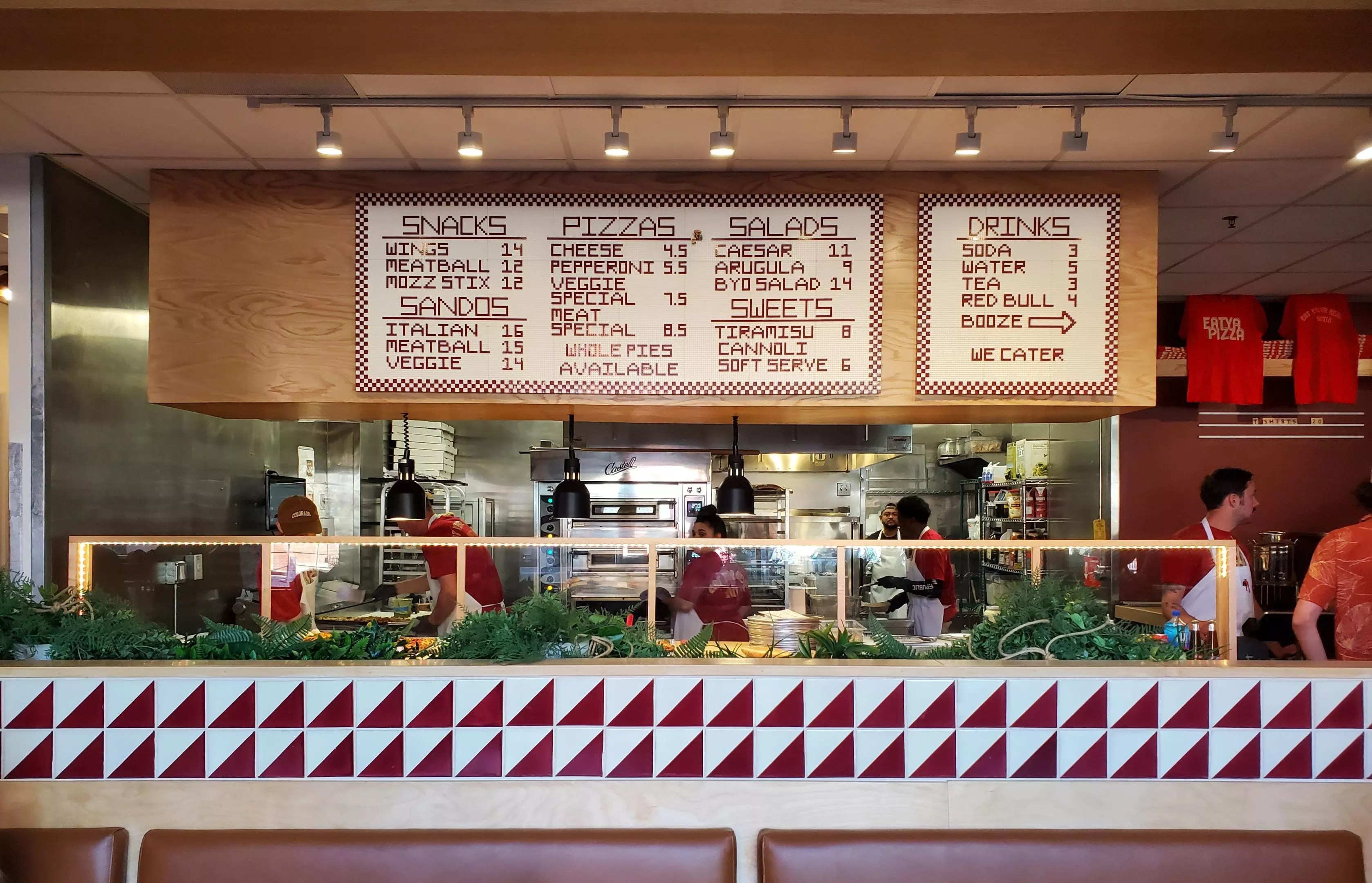 view of a menu hanging over an ordering line inside a restaurant