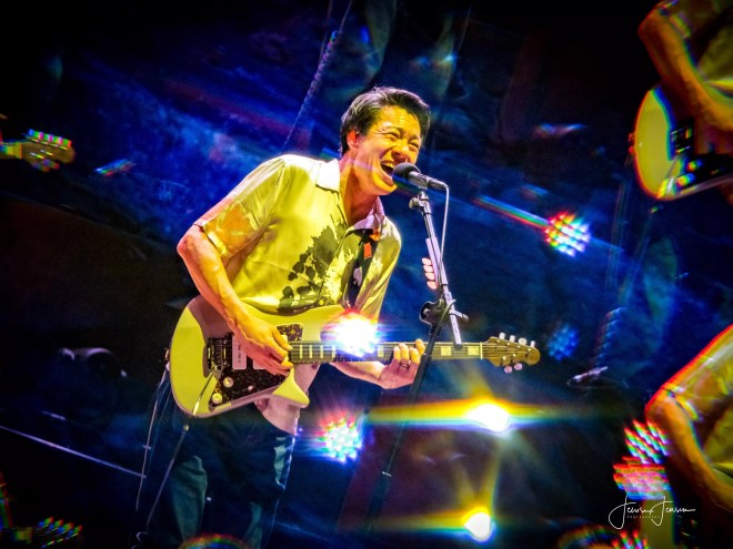 man playing guitar and singing