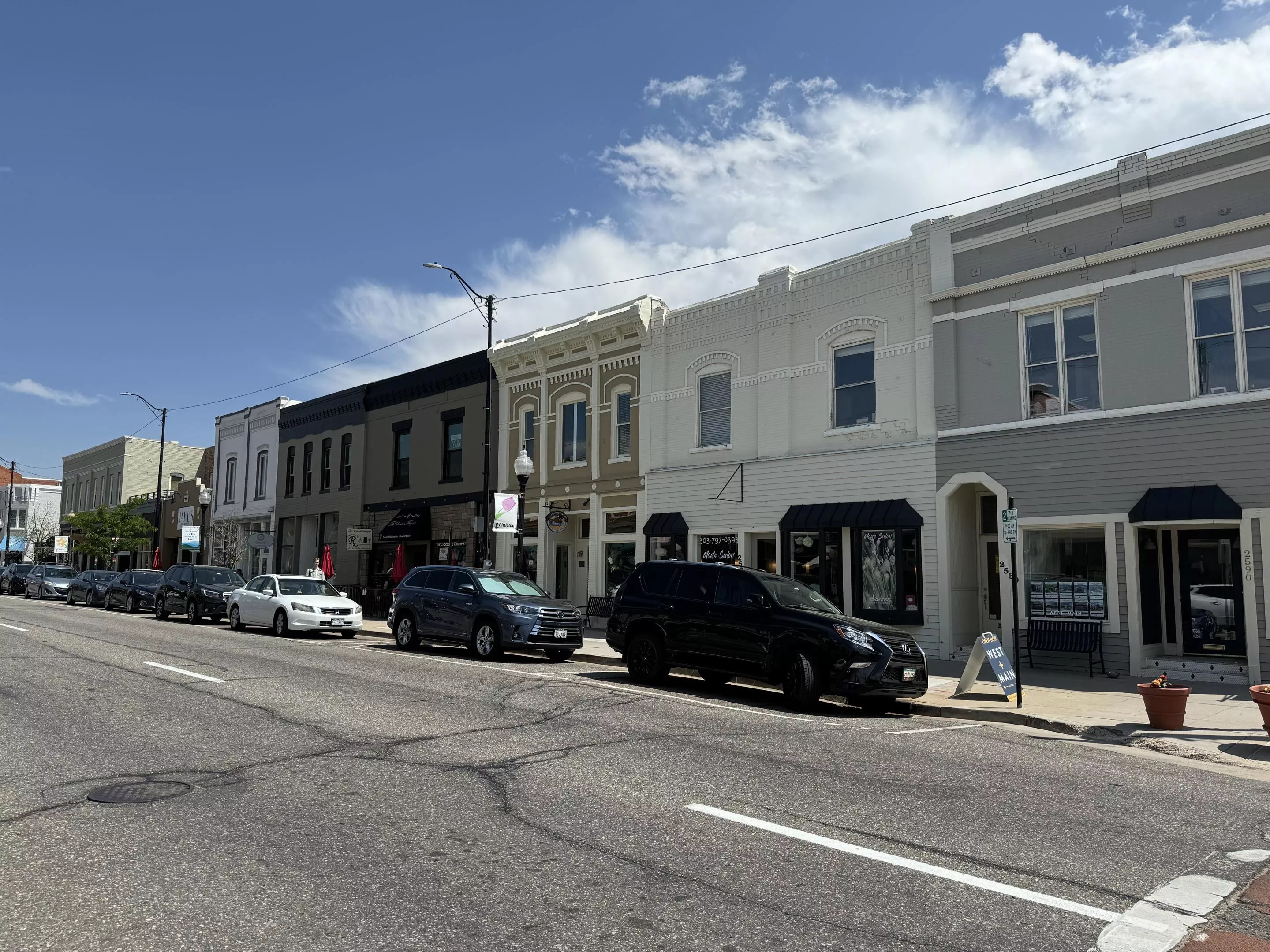Buildings along a street with cars parked in front