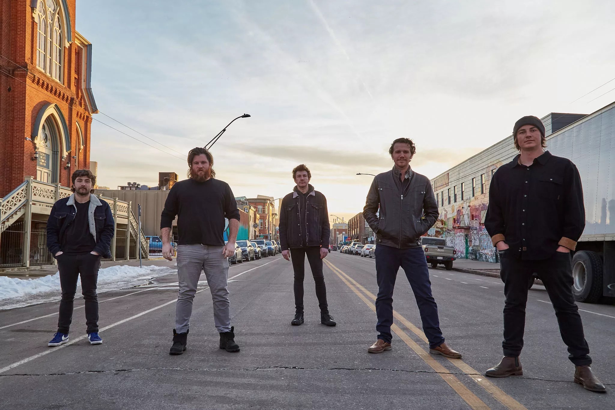 five men standing in a street