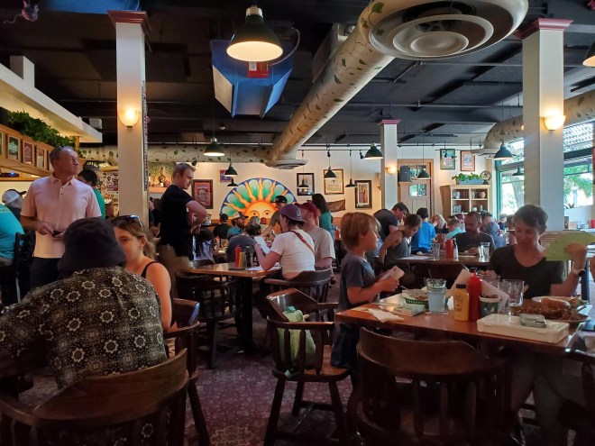 people sitting at tables inside a restaurant