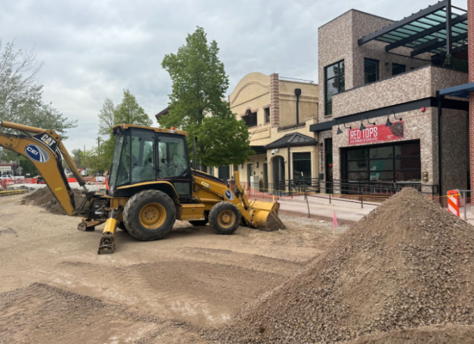 a bulldozer in front of a storefront