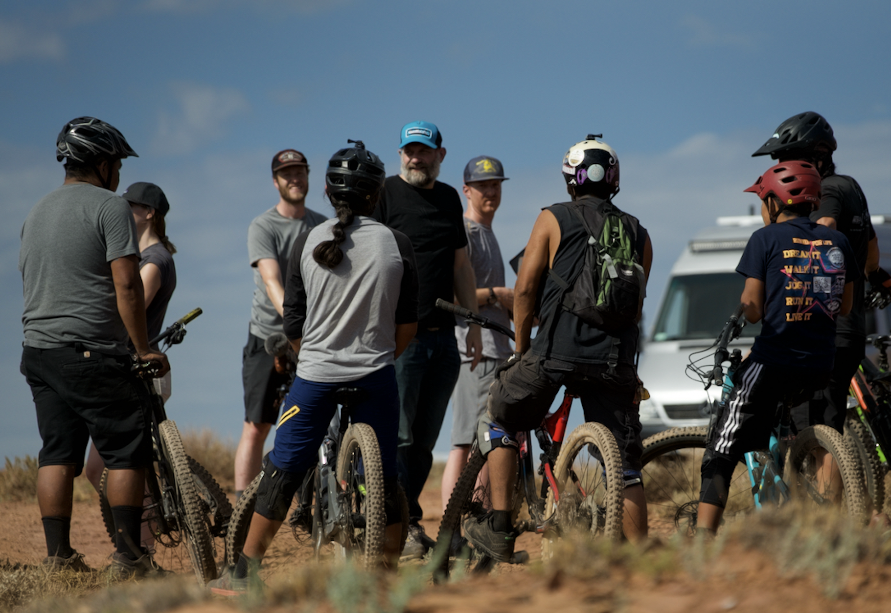 People on mountain bikes talking to film director T.C. Johnstone in Navajo Nation.