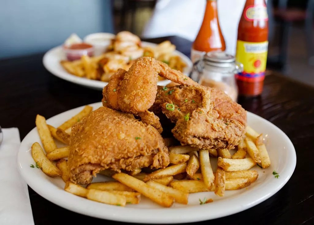 a plate of fried chicken and french fries