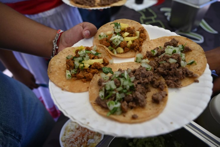 a plate of four street tacos