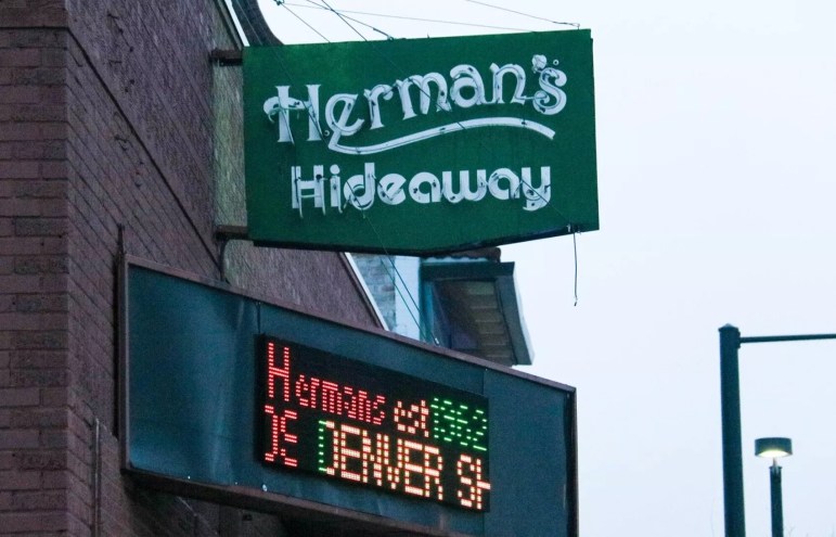 green sign of Herman's, a Denver music venue.