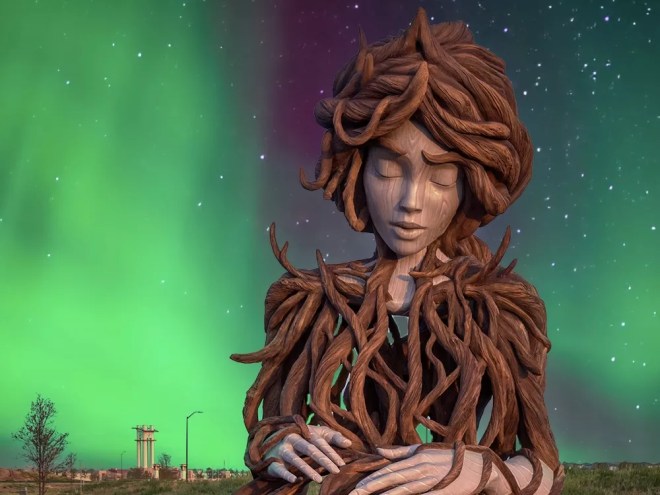A twisted wood sculpture of a woman backdropped by the northern lights