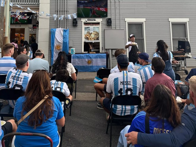 people in blue and whte striped jerseys sitting in chairs outside