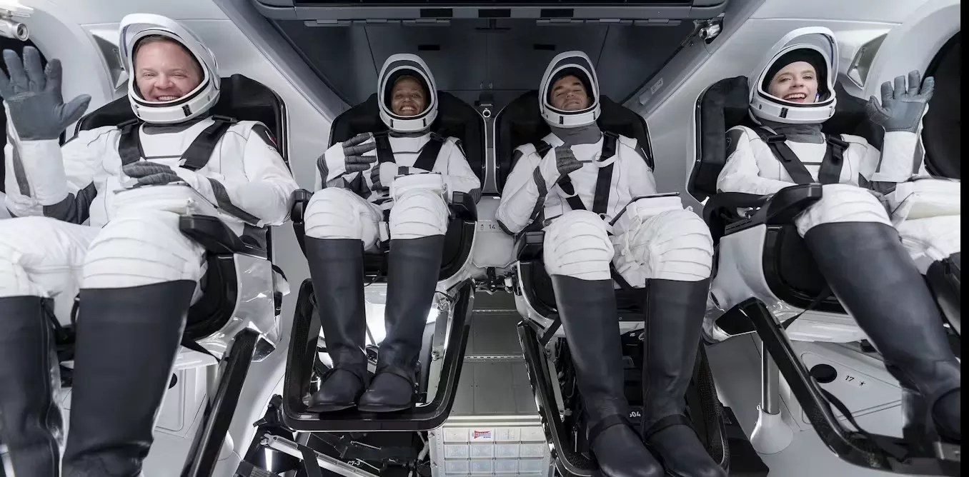 four astronauts coming back from space