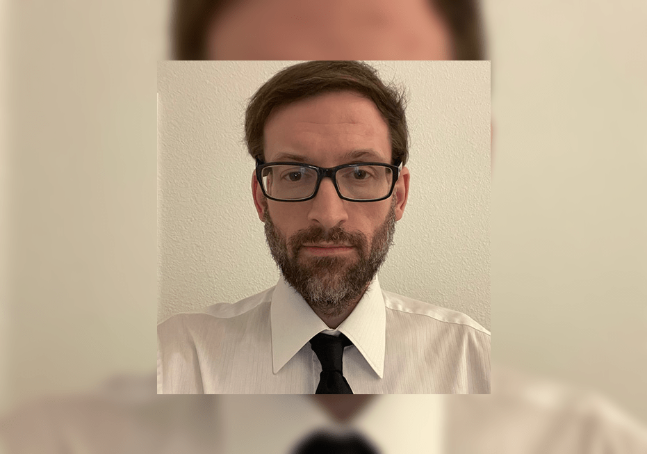 Professor in shirt, tie and glasses