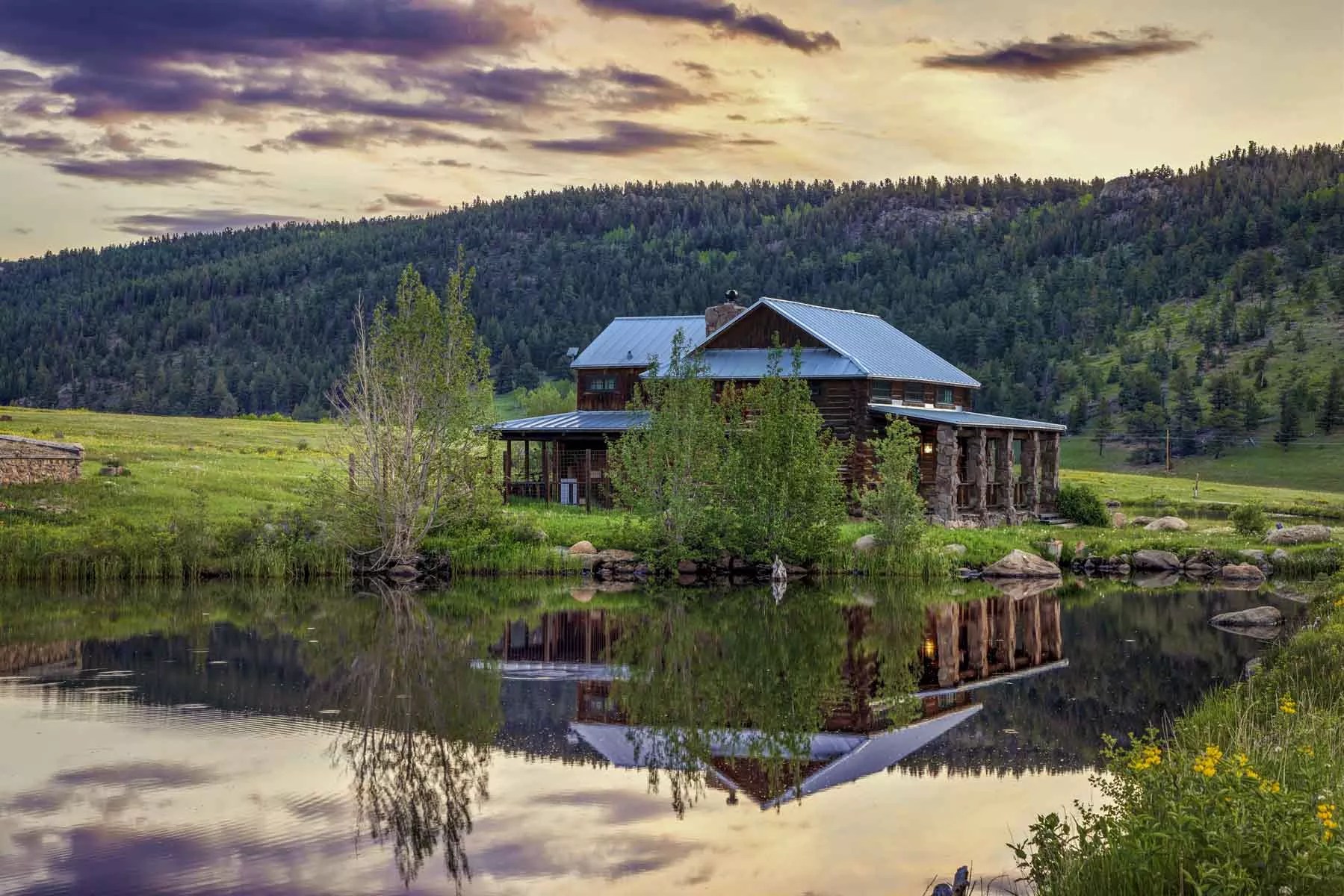log home with mountains behind
