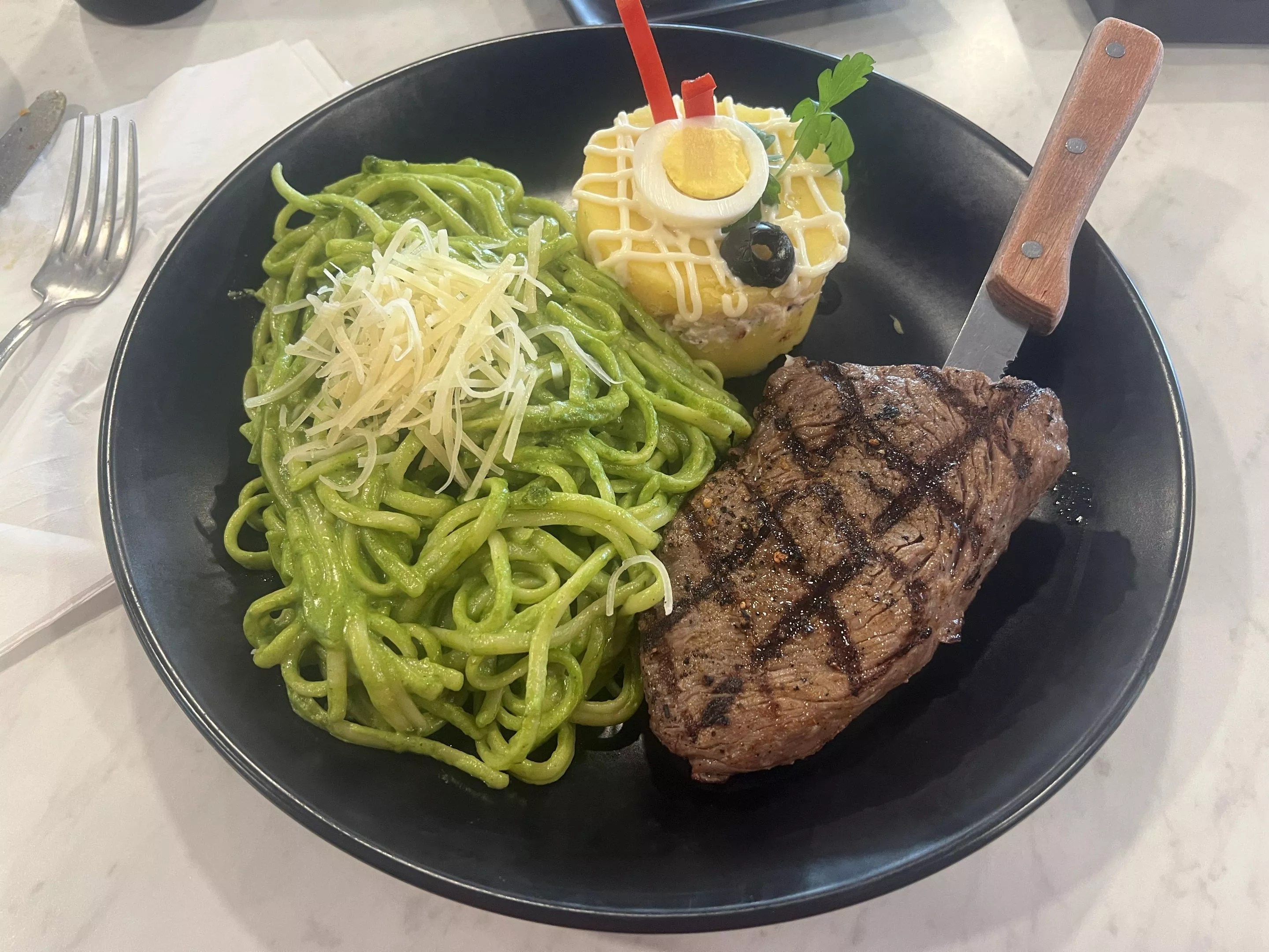 steak and green spaghetti on a plate