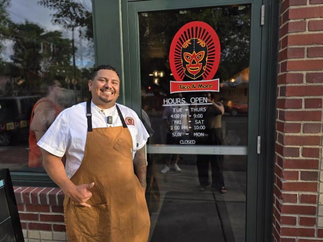 man posing in front of a glass door