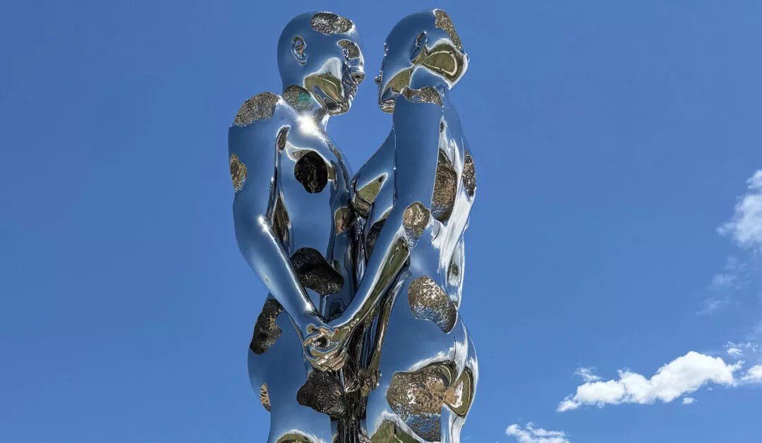 sculpture of metalic man and woman
