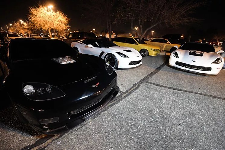 Corvettes and sports cars at a parking lot car gathering
