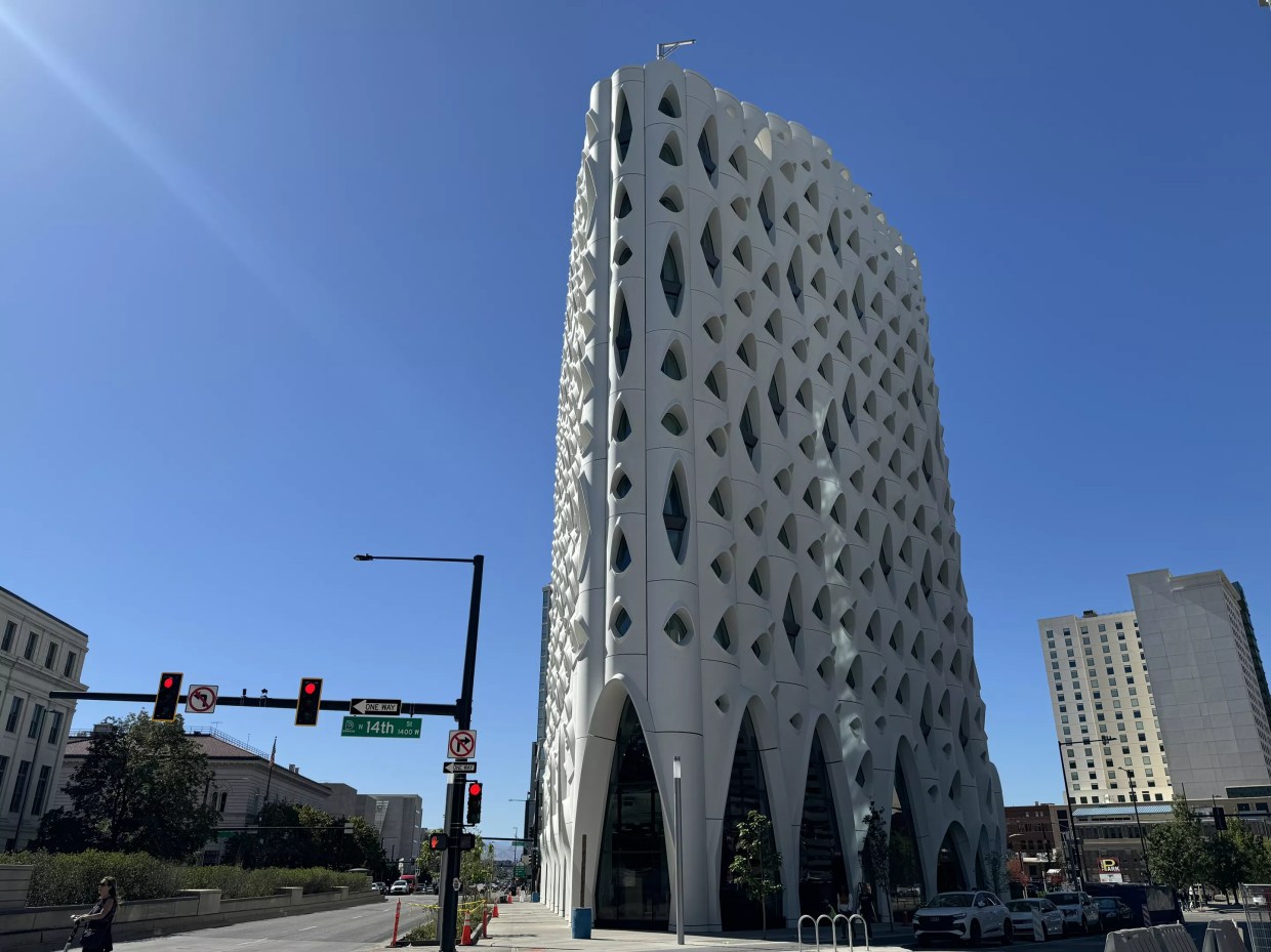 tall building with weird windows against blue sky.