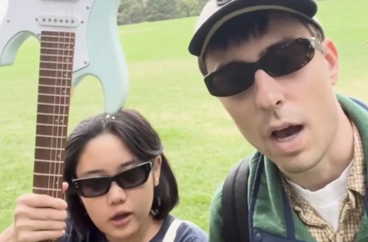 two people with sunglasses in a park