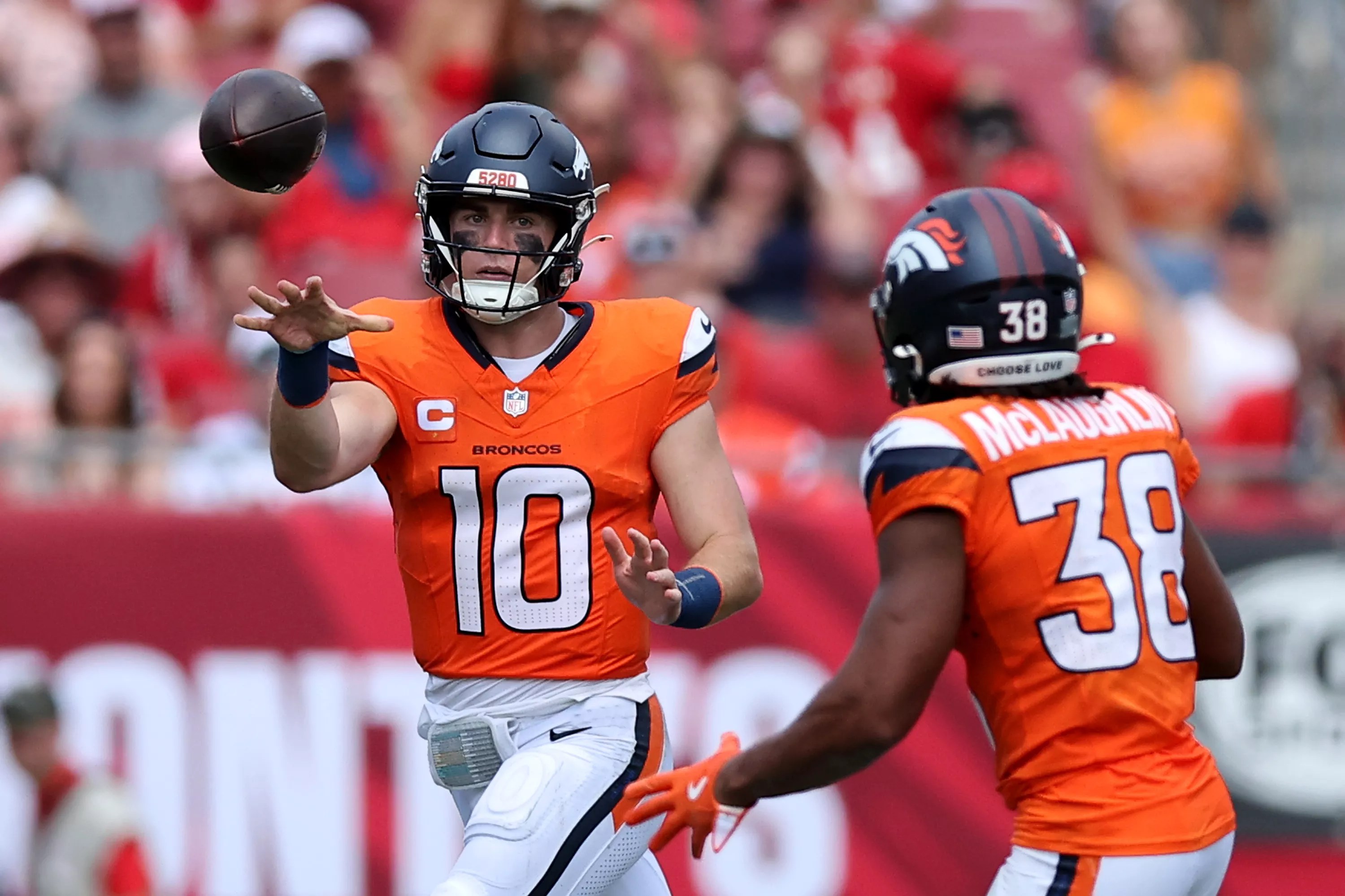Bo Nix throws pass to Denver Broncos running back