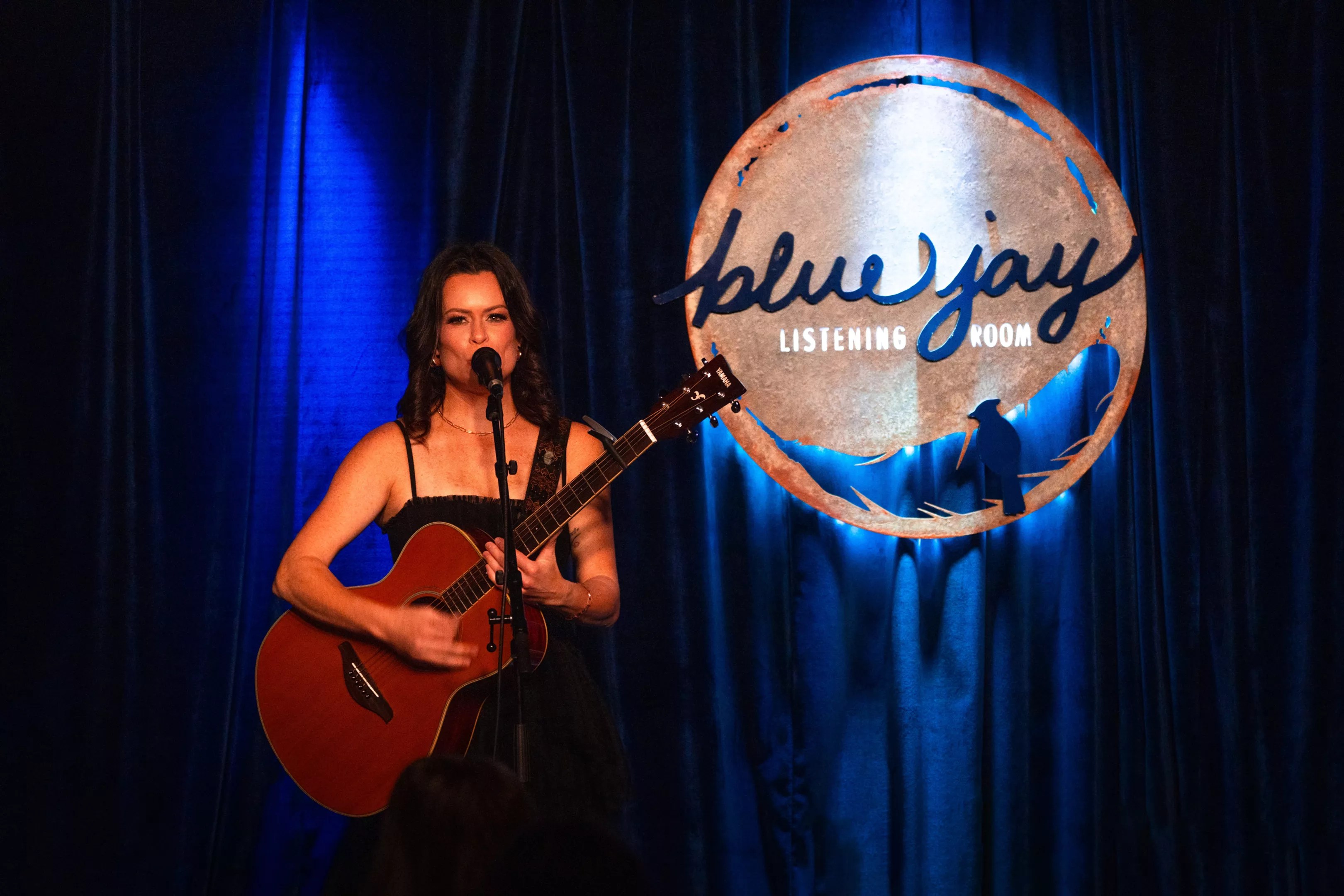 woman with guitar singing