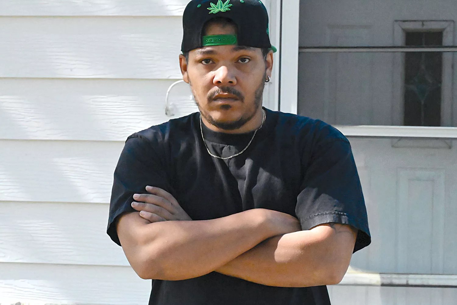 rapper in black hat and shirt