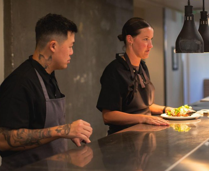 two chefs standing at a counter