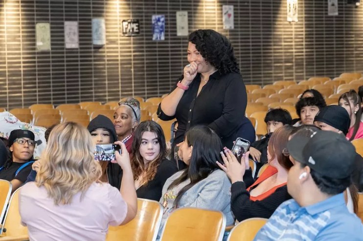 Teacher in auditorium with her students