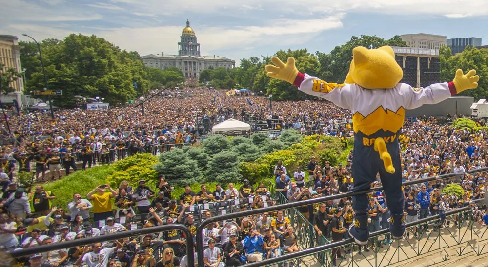 big crowd with basketball mascot in front