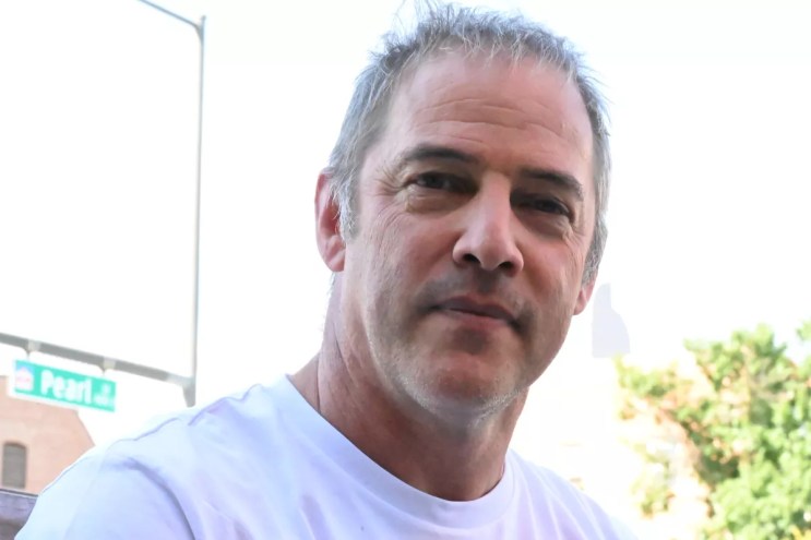 A man looks at the camera.