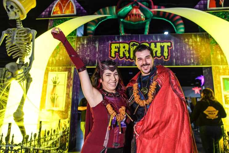 two people wearing costumes and pretzel necklaces