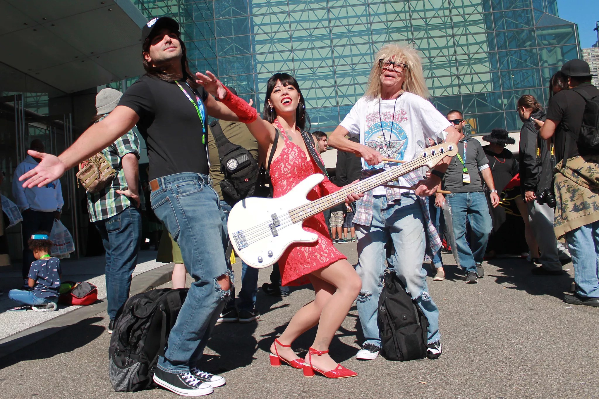 Three people dressed up as Wayne, Cassandra, and Garth from Wayne's World at New York ComicCon 2019.