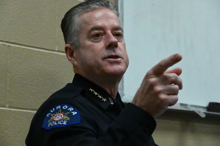 A man speaks and points.