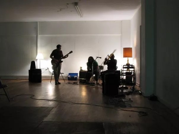 band members practicing in an empty room