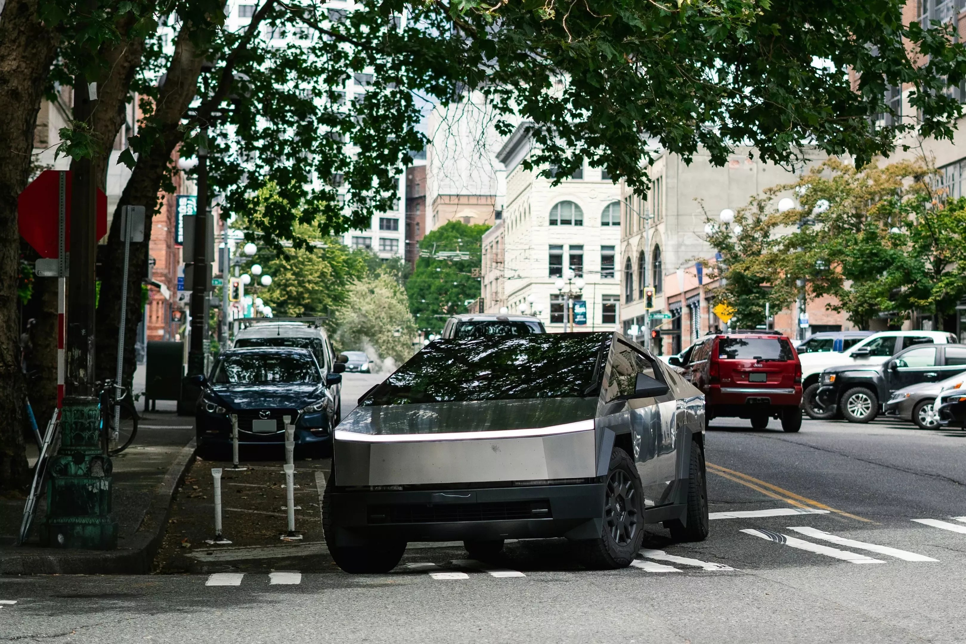 Tesla cybertruck under trees